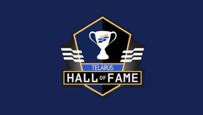 A dark blue emblem with a golden outline features a white trophy icon in the center. Below the trophy, the word "TELARUS" is written in blue, with "HALL OF FAME" in larger white text against a black background at the bottom of the emblem. This iconic image is perfect for enhancing your blog's SEO with relevant keywords.