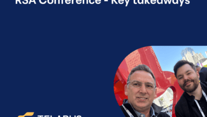 Two men smile at the camera with city buildings behind them. A blue overlay displays “RSA Conference 2025 - Key takeaways,” highlighting top cybersecurity insights, with the Telarus logo in the lower left corner.