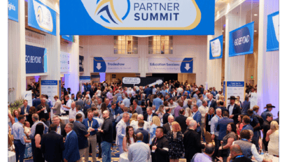 A large crowd of people networking and mingling in a brightly lit convention hall beneath a Telarus Partner Summit 2025 banner, with signs for tradeshow and education sessions offering reasons to attend.