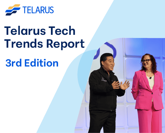Two people stand and smile on stage in front of a blue and white background. Text reads: "Telarus Tech Trends Report 3rd Edition" with the Telarus logo, highlighting insights like how to use AI for business innovation.
