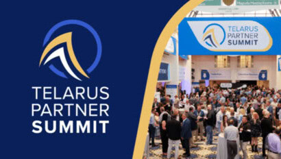 A large group of people gather at an indoor event under a banner that reads "Telarus Partner Summit." The Telarus logo and event name are also displayed on a blue background to the left.